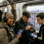 Busy New York City commuters listening to satellite radio in traffic during winter snowfall