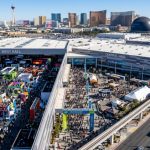 Aerial view of the Las Vegas Convention Center during CES 2027 with crowds of tech professionals on the exhibit floor